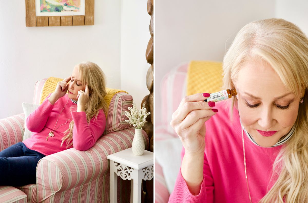 soothe aches and pains_3 A woman in a pink sweater applies essential oil to her temples while sitting in a striped armchair, seeking relief from everyday aches, then holds the oil bottle close to her forehead.