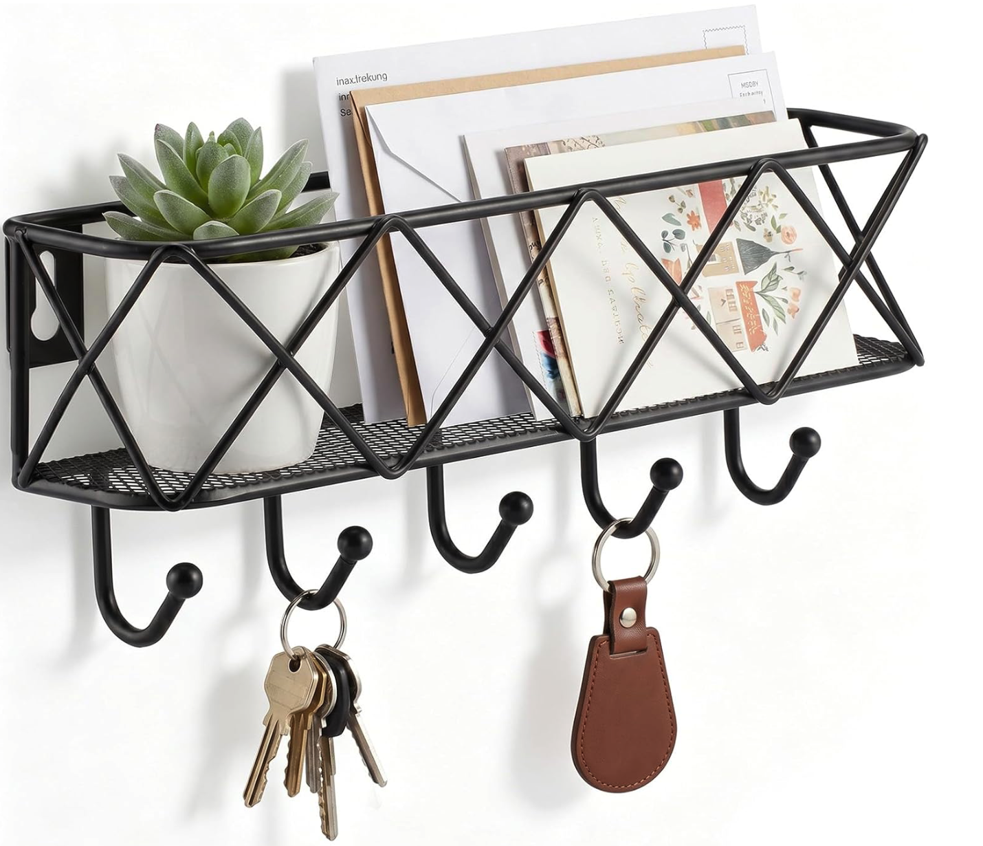 A black metal wall-mounted organizer containing a potted succulent, envelopes, and misplaced items like mail, with five hooks below holding a set of keys and a leather keychain.